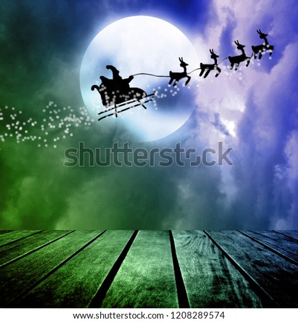 Santa flying over full moon