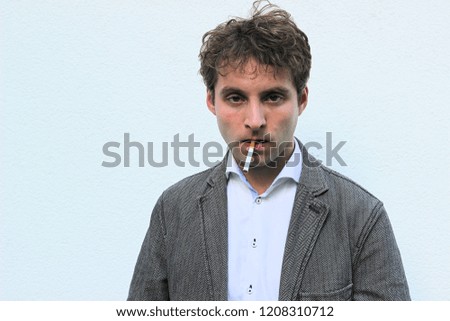 Young  handsome fashion model man. Expression face. White background.