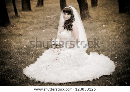 Bride in a park. wedding dress. Bridal wedding bouquet of flowers