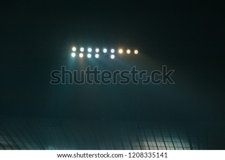 Hight lighter. Light tower lit at a football stadium during nigh time. Royalty-Free Stock Photo #1208335141