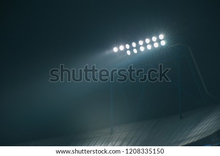 Hight lighter. Light tower lit at a football stadium during nigh time. Royalty-Free Stock Photo #1208335150