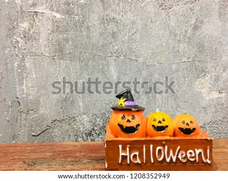 Happy Halloween, 3 Pumpkin on table wood with dark wall background, halloween concept.