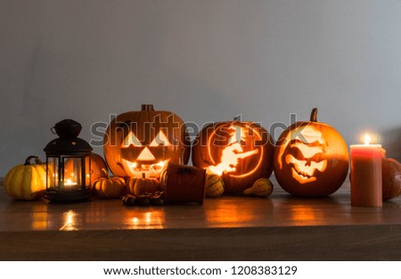 Halloween decorated pumpkins with candles and lamp