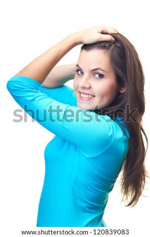 Attractive smiling young woman in a blue shirt standing with hands up. Isolated on white background