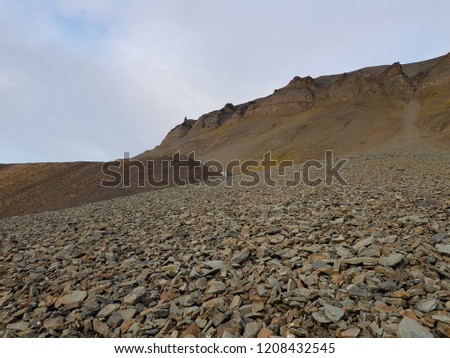 massive mountain with loose rock slide stone on svalbard, bear valley