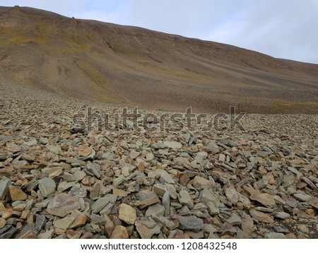 massive mountain with loose rock slide stone on svalbard, bear valley