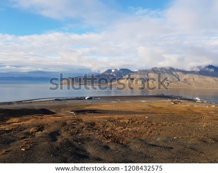 beautiful overview photo of parts of longyear city airport with mighty mountains and sea scape