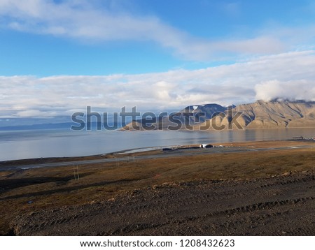 beautiful overview photo of parts of longyear city airport with mighty mountains and sea scape