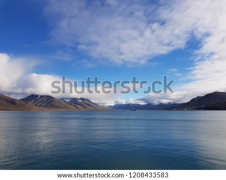 blue sea and mountain view with longyear city in the fjord on svalbard island