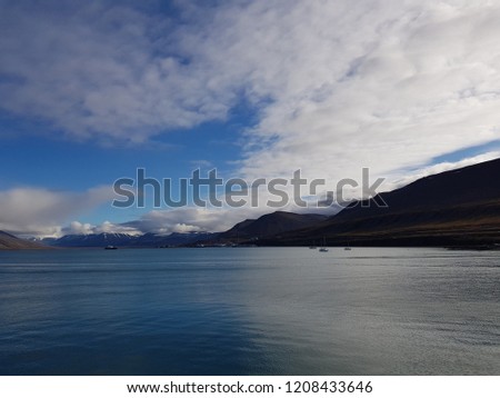 blue sea and mountain view with longyear city in the fjord on svalbard island