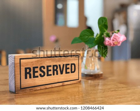 "Reserved" wooden label on the table