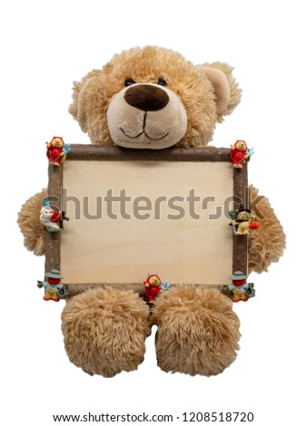 Cute brown teddy bear holding halloween wooden frame with cartoon character on it.  Isolated against white background. Halloween theme concept.