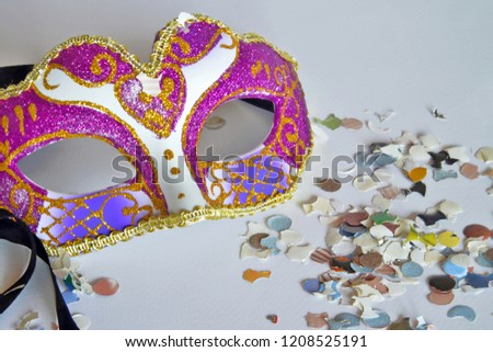 carnival mask with colorful confetti