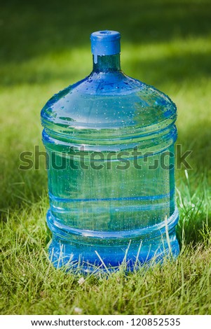 water big bottle on green grass background
