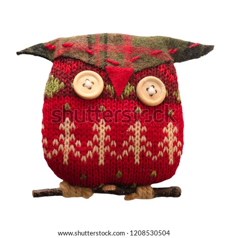 Christmas toy owl made from red and green knitted thread. Isolated white background.