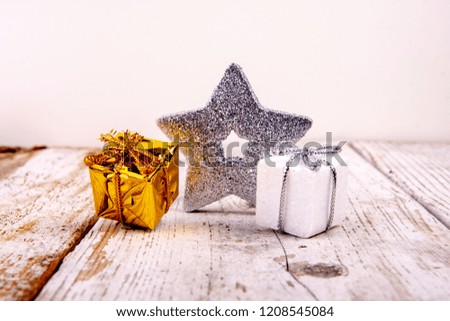 silver star with presents on wood