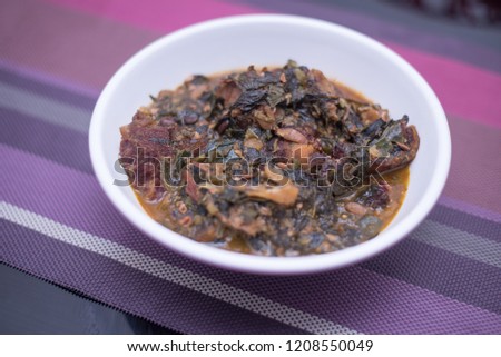 A plate of Ogbono soup with mixed okra, dried fish and and bush meat