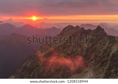 Sunset in the mountains coloring clouds in orange