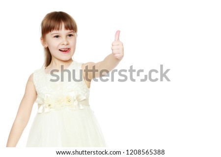 Little girl holding her thumb up. Concept Happy childhood, holiday, birthday.Isolated on white background