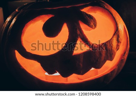 Halloween pumpkin head jack lantern with burning candles. Decoration for Halloween celebration.