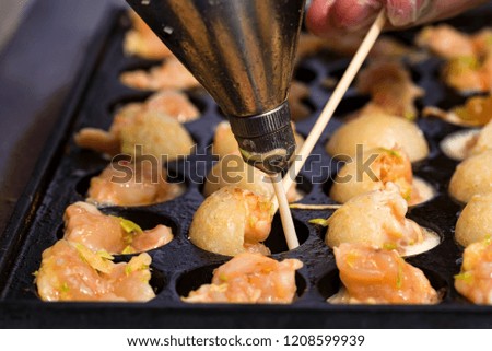 Close up baking prawns in baking pan with holes