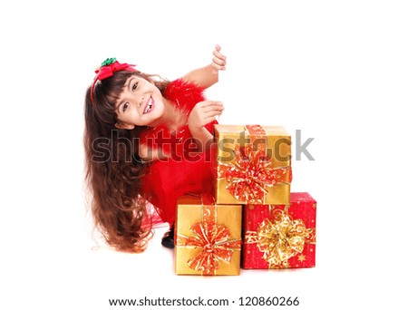 Happy girl in Christmas dress holding the blank board sitting on the her knees