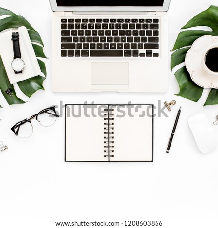 Home office workspace mockup with laptop, tropical leaves Monstera, clipboard, notebook and accessories on white background. Flat lay, top view
