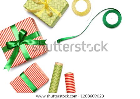 Gift boxes, packing paper, scissors, ribbon on white background. Festive background, congratulation, gift wrapping, Christmas and new year theme. Flat lay, top view, copy space.