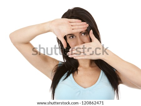 casual brunette  showing frame gesture on white isolated background