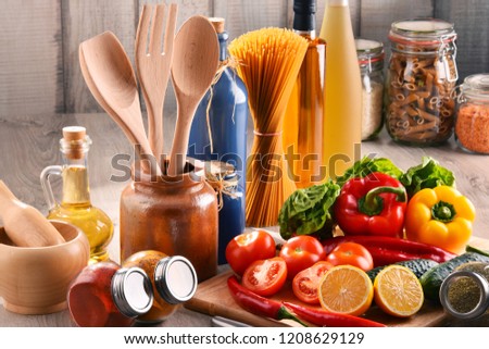 Composition with assorted food products and kitchen utensils on the table