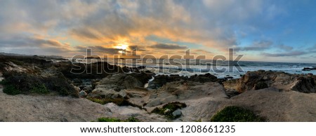 A panoramic photo of a coastal sunset from Pebble Beach, California.