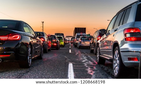 Vancouver, British Columbia - Canada. Traffic jam on a busy highway at rush hour. Cars in line, bumper to bumper, stuck in traffic at dusk on a clear sky night. Royalty-Free Stock Photo #1208668198