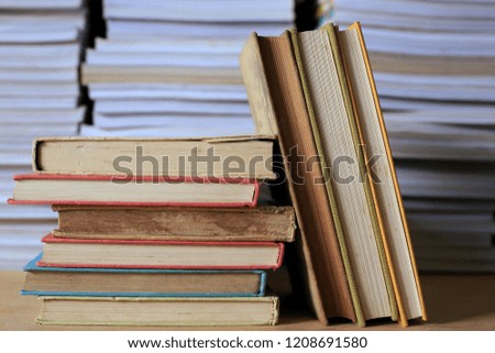 Close-up of old books stacked in library many books stacked in the background selective focus and shallow depth of field