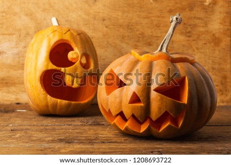 Smiling carved pumpkin on a rustic wood background
