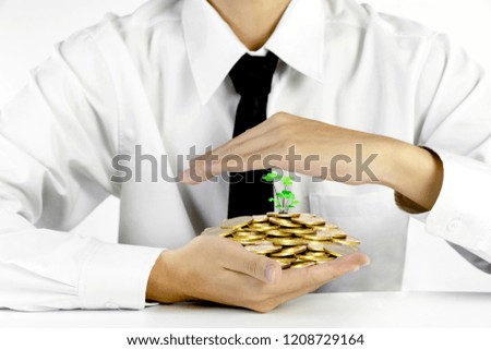 businessman hands protecting piles of golden coins,Lucky economic growth concept