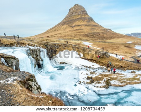 Viewpoint of Kirkjufell mountain and Kirkjufellfoss waterfall, the most popular photograph point in Iceland, cold and freeze water in winter season