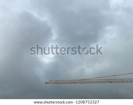 Construction crane and storm clouds weather