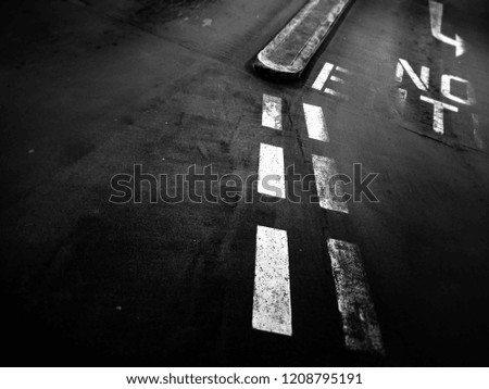 Gritty black and white photo of road markings