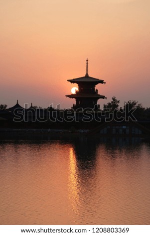 The beautiful sunset view with the classical buildings reflection in water and warm sunlight