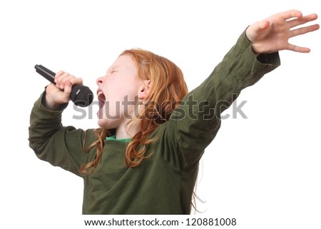 Young red haired girl singing into microphone on white background