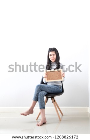 Beautiful young Asian woman Bulletin Board guts pose gesture sitting in a chair on white wall background, Picture includes copy space, For the holiday background design. discount Business