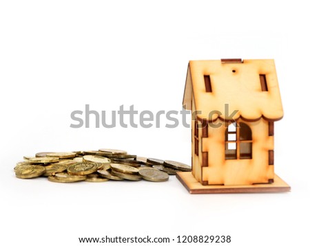 Russian metal rubles and a wooden house as an illustration of a mortgage