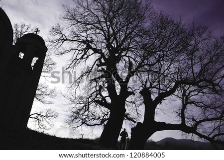 halloween scene: church and silhouette of a tree and a man