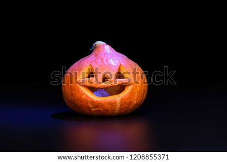Halloween pumpkin isolated on black background with blue backlig