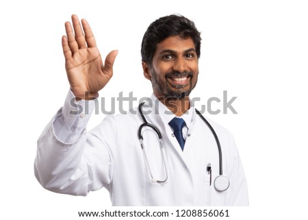 Friendly indian medic waving hand  smiling with cheerful expression isolated on white studio background