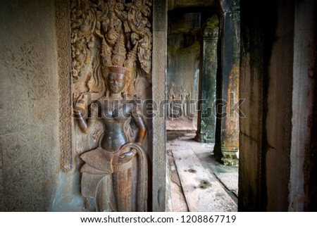 Dancing Apsaras an old Khmer art carvings on the wall.Vintage Culture and Religion Art.Guardian Angels at Angkor Wat. Seam Ream  Combodia.Photo select focus.