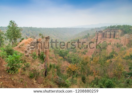 view of Pha Sing Liao or Pha Singh Leaw Canyon and green forest with blue sky background, attraction in Ban Tan, Hot District, Chiang Mai, northern Thailand.