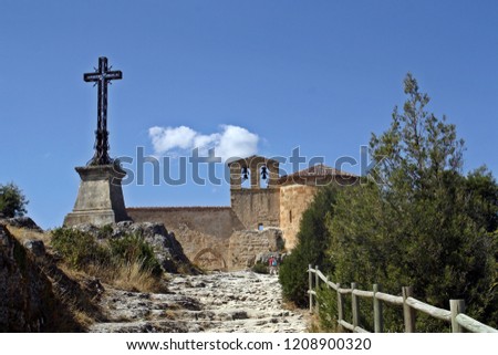 Bell tower and cross of the catholic hermitage of San Frutos in Segovia (Spain).