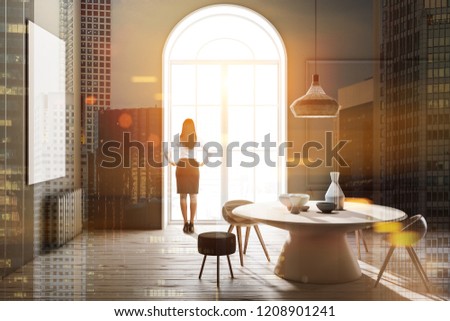 Businesswoman in modern dining room interior with gray walls, wooden floor, round table with vases and arched window. Toned image double expsoure