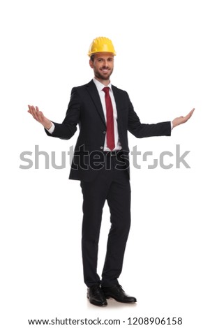 engineer ceo makes a welcoming hand gesture while smiling and standing on white background, full length picture
